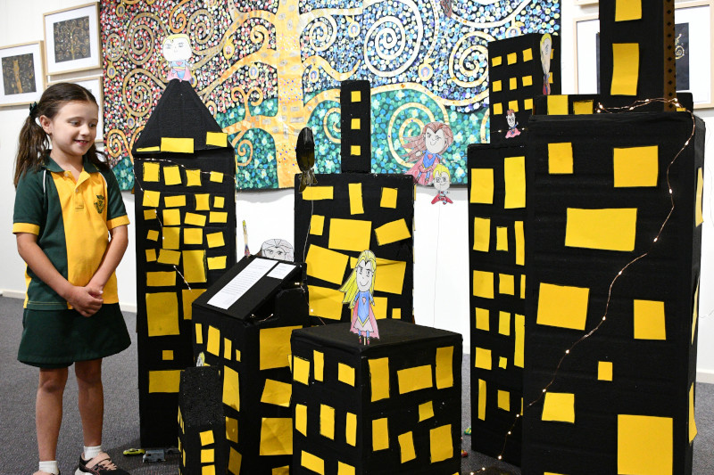 Thea with the Prep City Scape and Years One and Two Tree of Life (Background). Photo by Terry Griffin